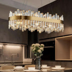  Chandelier light for dining room in gold with crystal raindrops and rectangular pendant design.